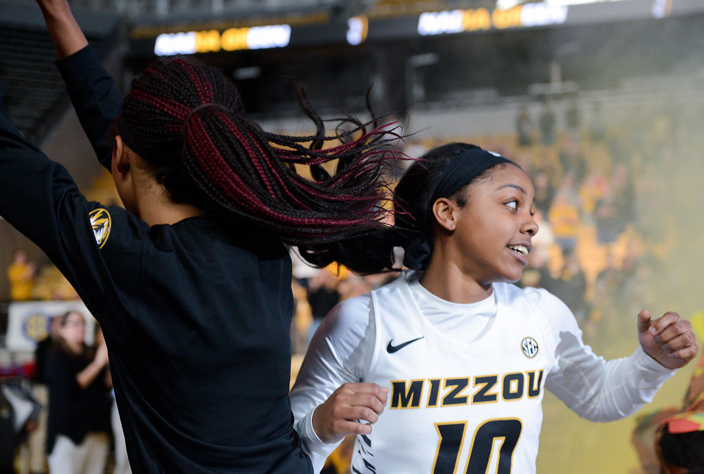 Elle Brown jumps in the air with teammate Nadia Green